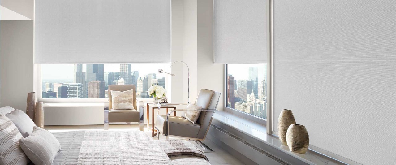 Bedroom with city skyline through the window.