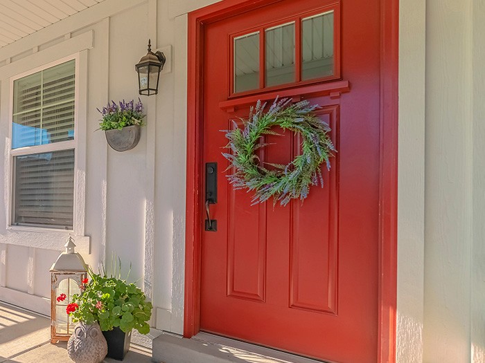 Bright red front door with lavender wreath 